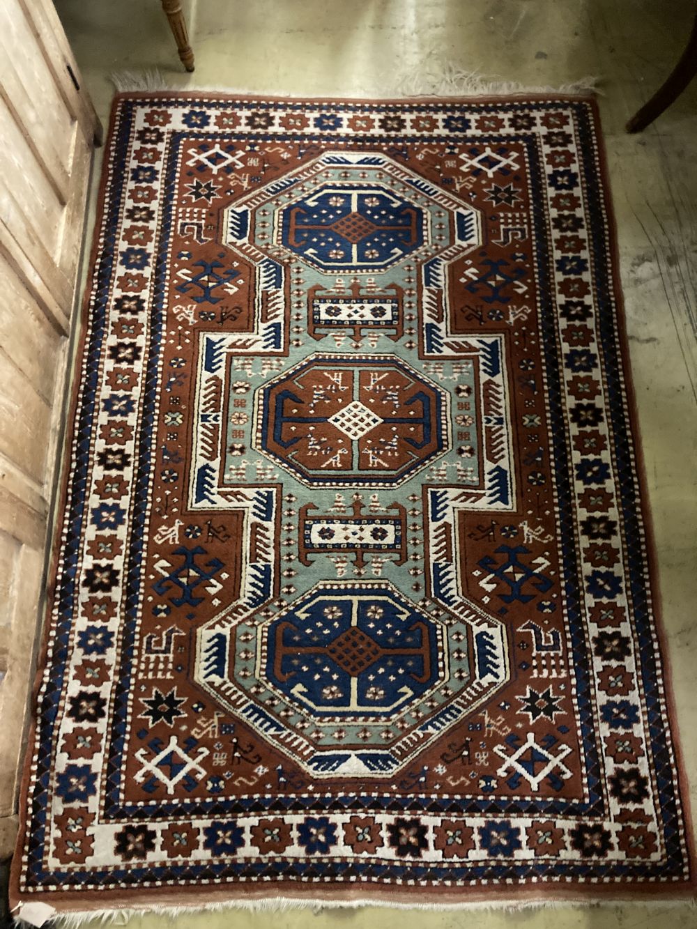A Caucasian Kazak style red ground rug, 170 x 116cm